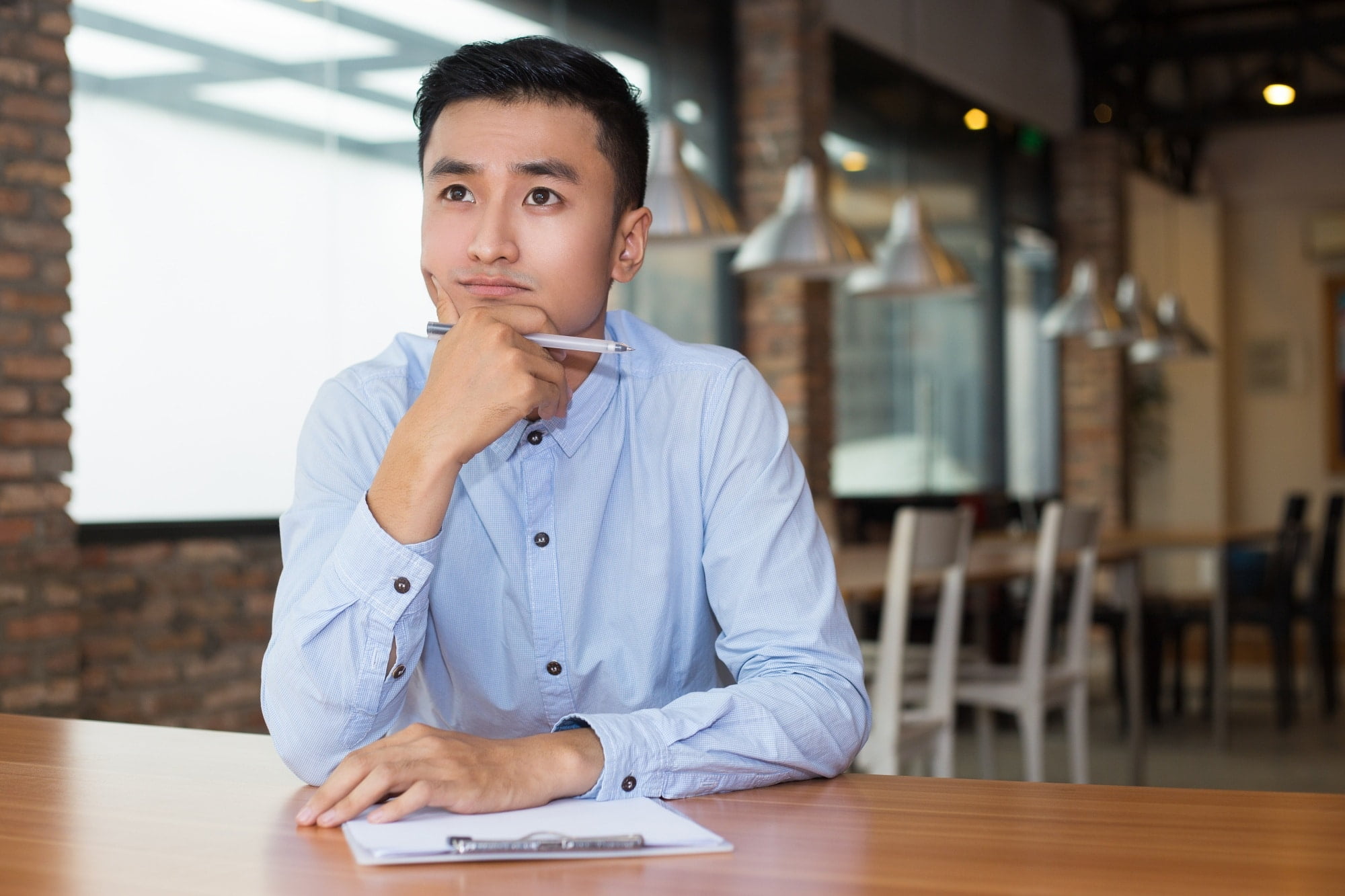 asian entrepreneur thinking on project in cafe